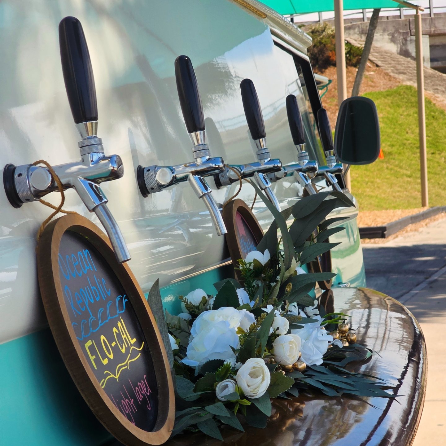 The teal Kombination bus, set up with drink taps.